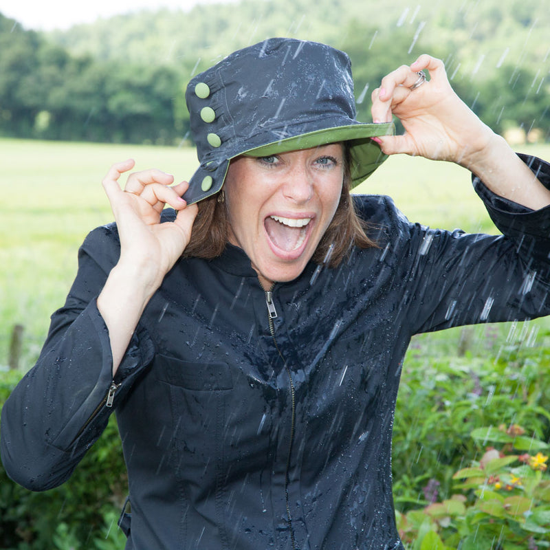 Olney Headwear Olivia Charcoal And Apple Green Wax Ladies Rain Hat On Woman Laughing In The Rain