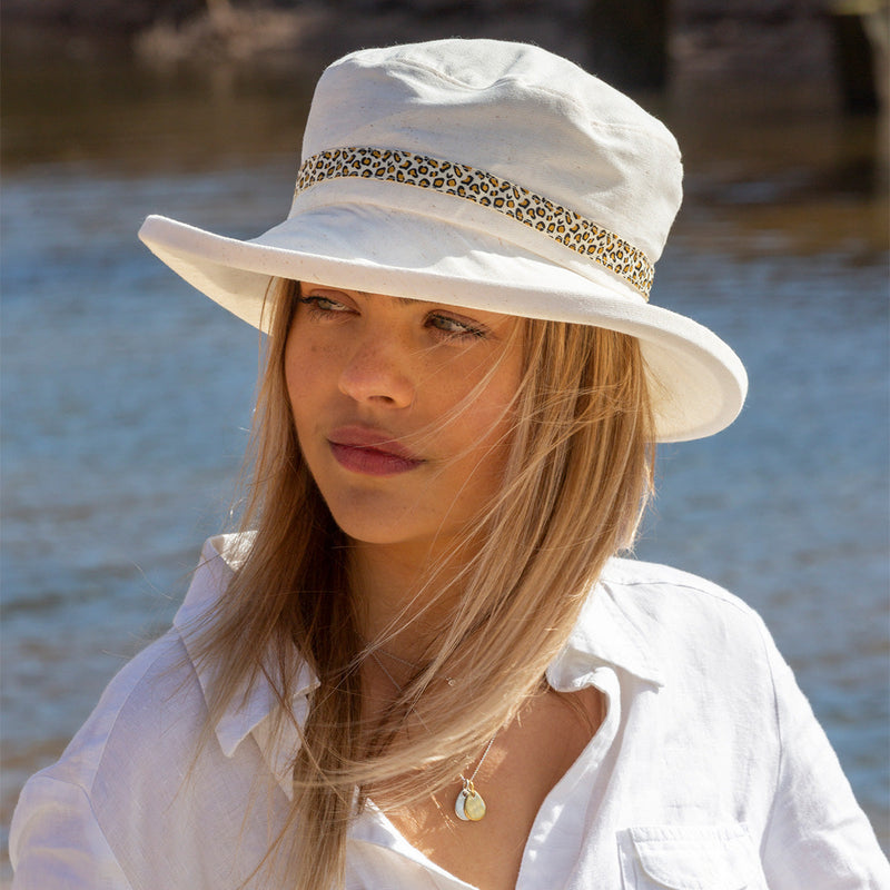 ladies cream sun hat with leopard skin ribbon trim round crown of sun hat