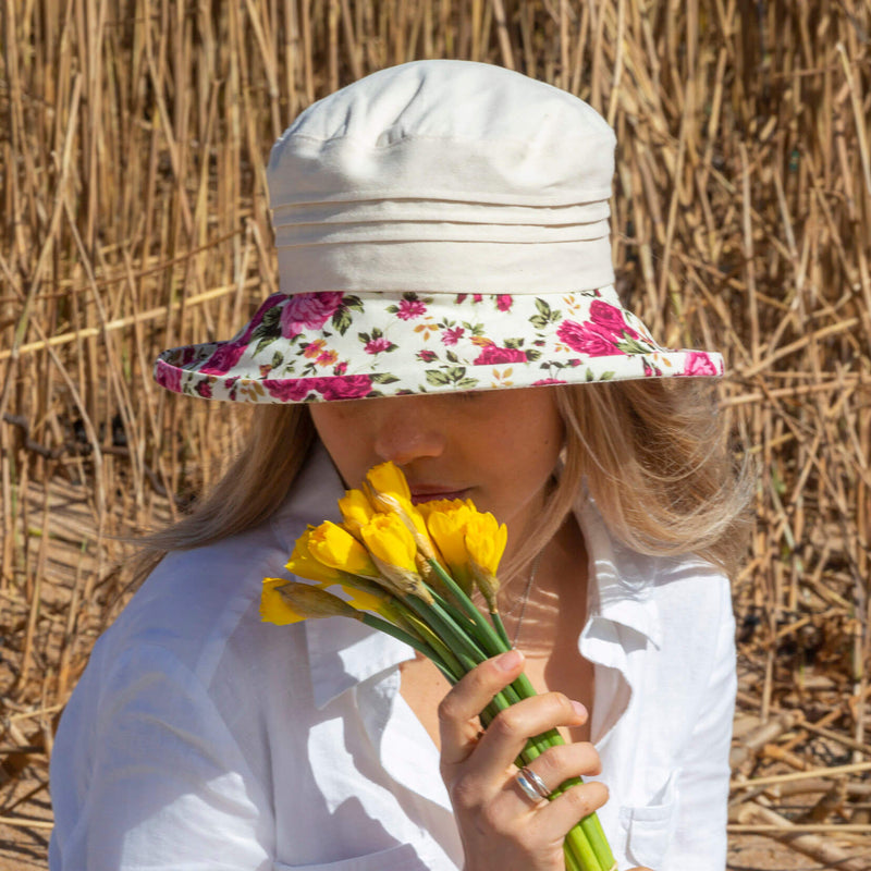 ladies cream sun hat with pink floral design brim on woman