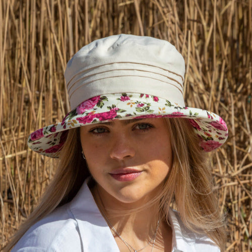 ladies  cream sun hat with pink floral brim on woman